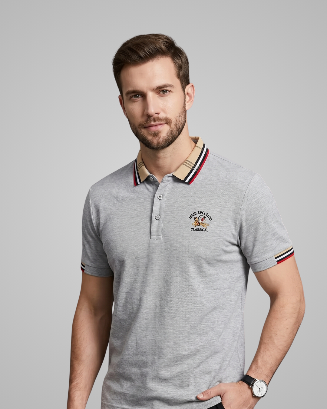 Man wearing a gray polo shirt with a brand logo on a gray background