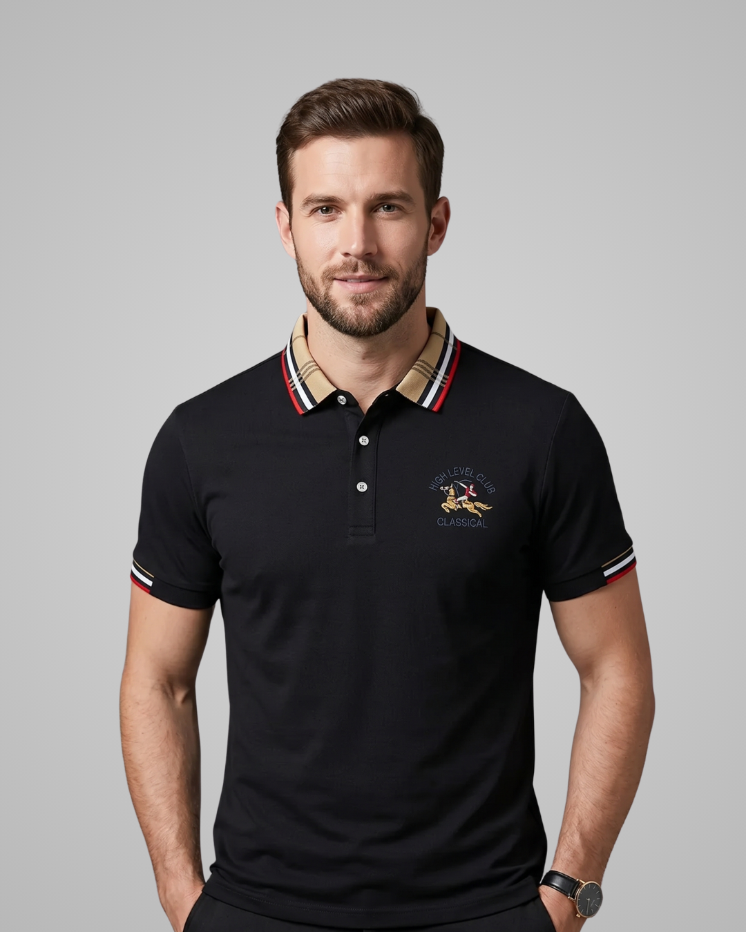 Man wearing a black polo shirt with a brand logo on a gray background