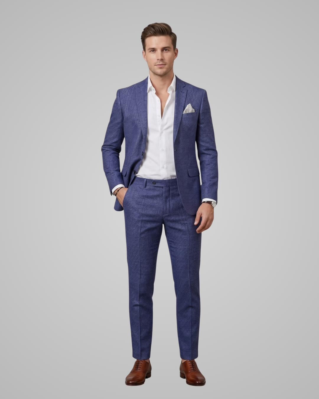 Man wearing a blue suit with a white shirt on a gray background