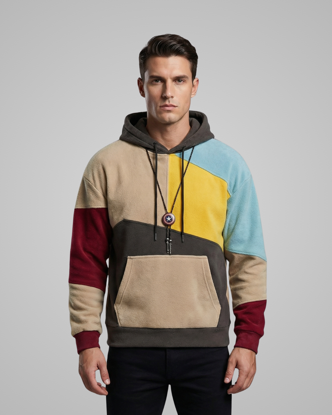 Man wearing a multicolored hoodie with a gray background