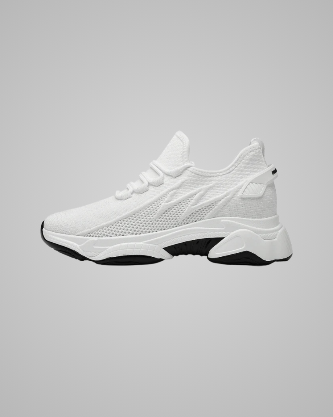 White sneaker with black sole on a gray background