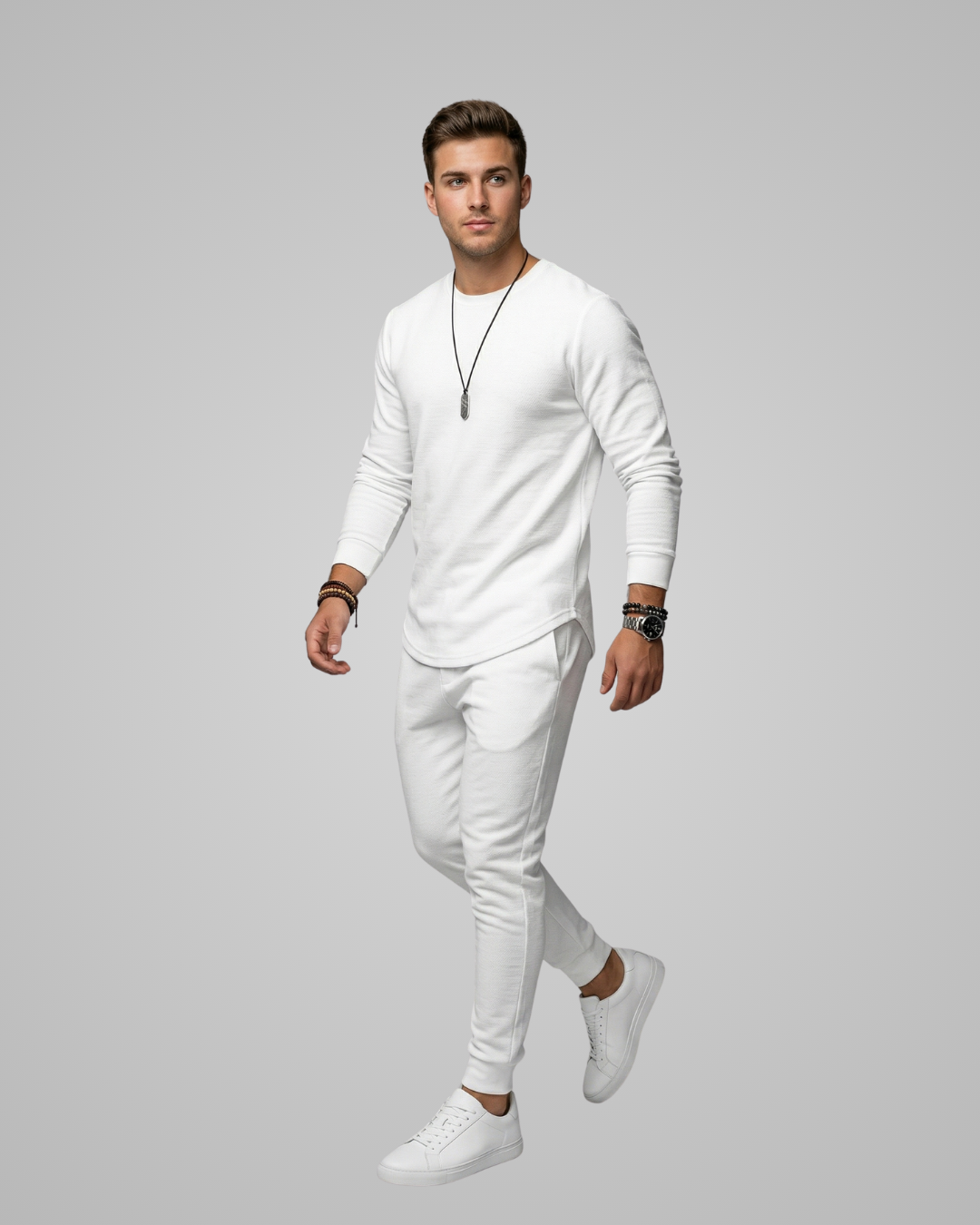 Man wearing a white outfit with sneakers on a gray background