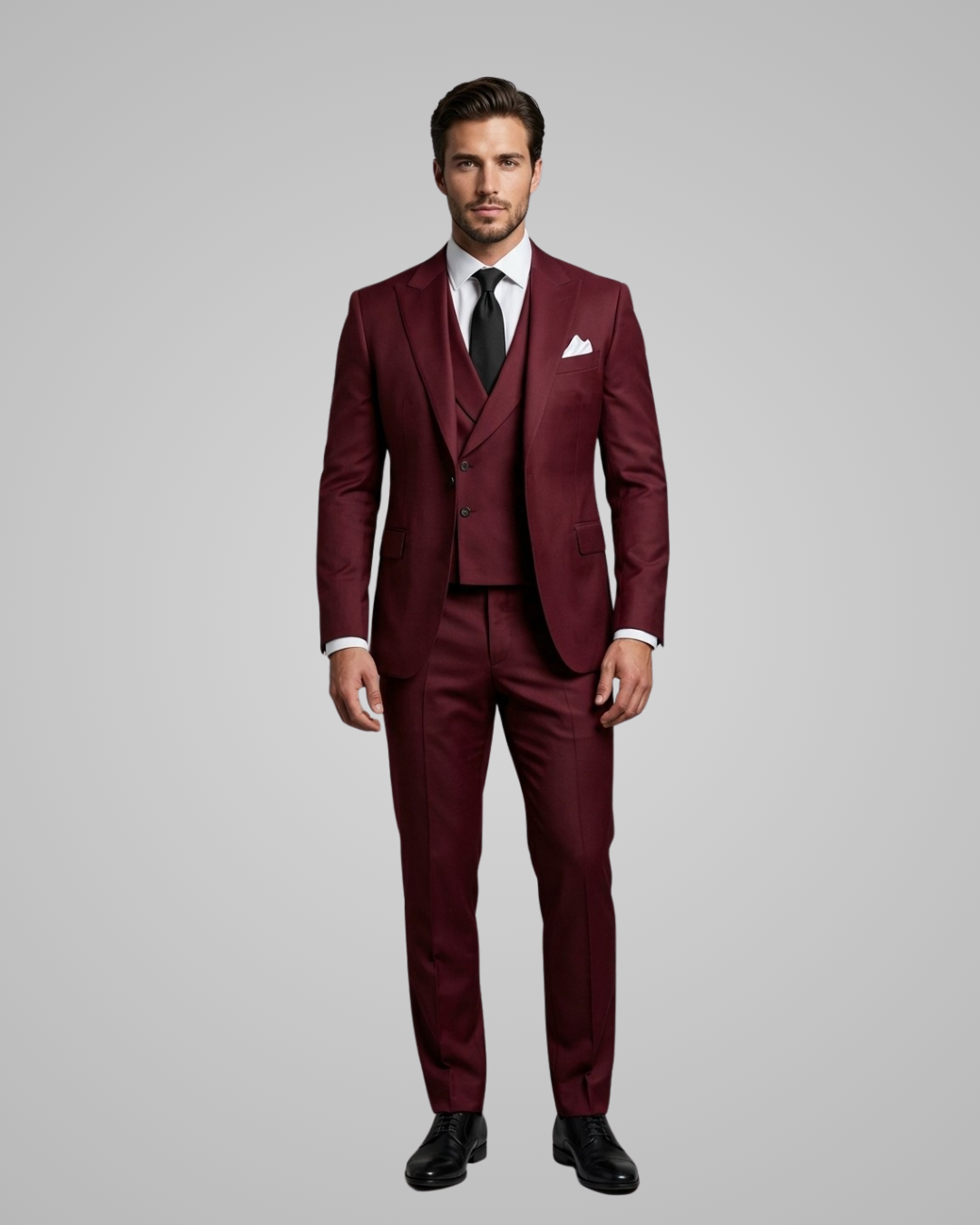 Man wearing a burgundy suit with a white shirt and black shoes on a gray background