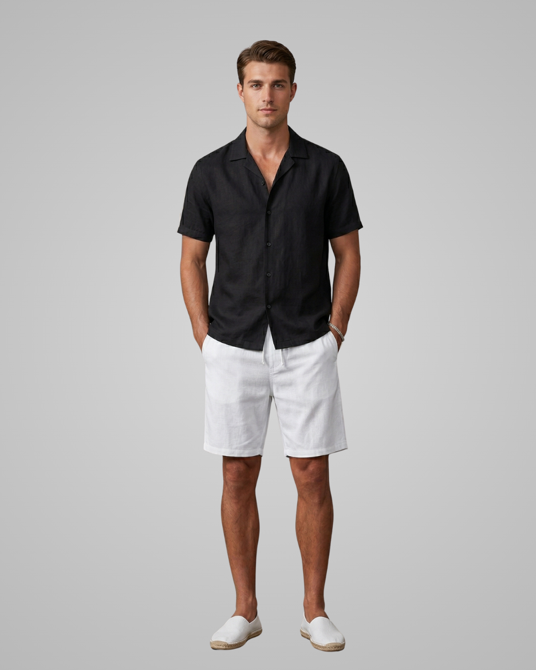 Man wearing a black shirt and white shorts on a gray background