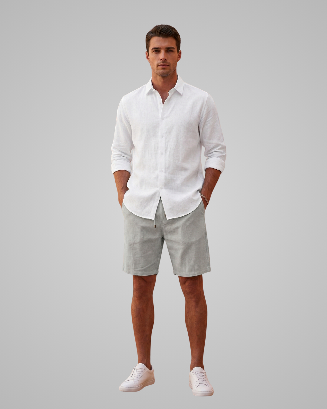 Man wearing a white shirt and light gray shorts on a plain background