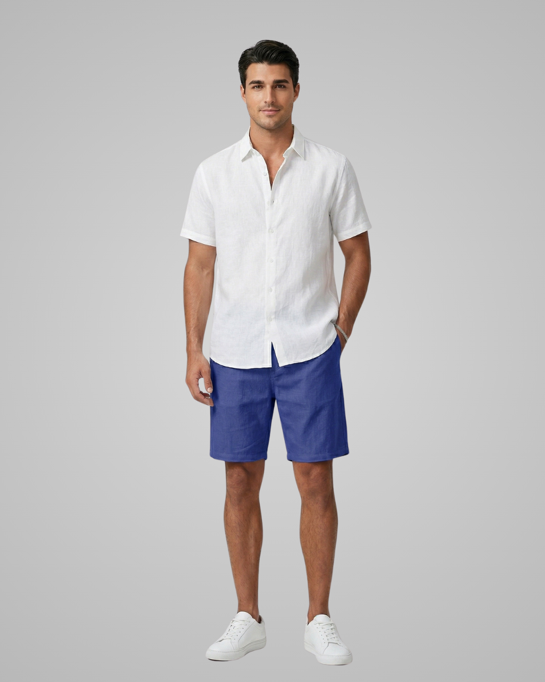 Man wearing a white shirt and blue shorts on a gray background