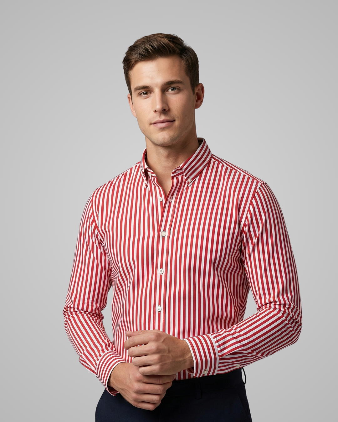 Man wearing a red and white striped shirt against a gray background