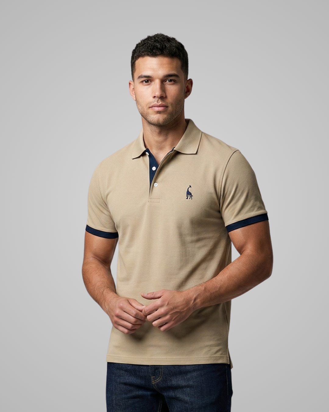 Man wearing a beige polo shirt with a logo on a gray background