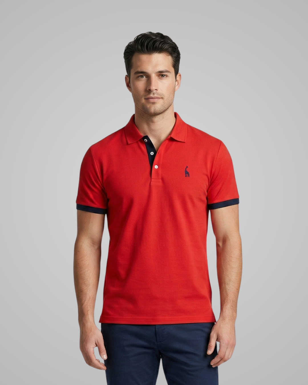 Man wearing a red polo shirt with a logo on a gray background