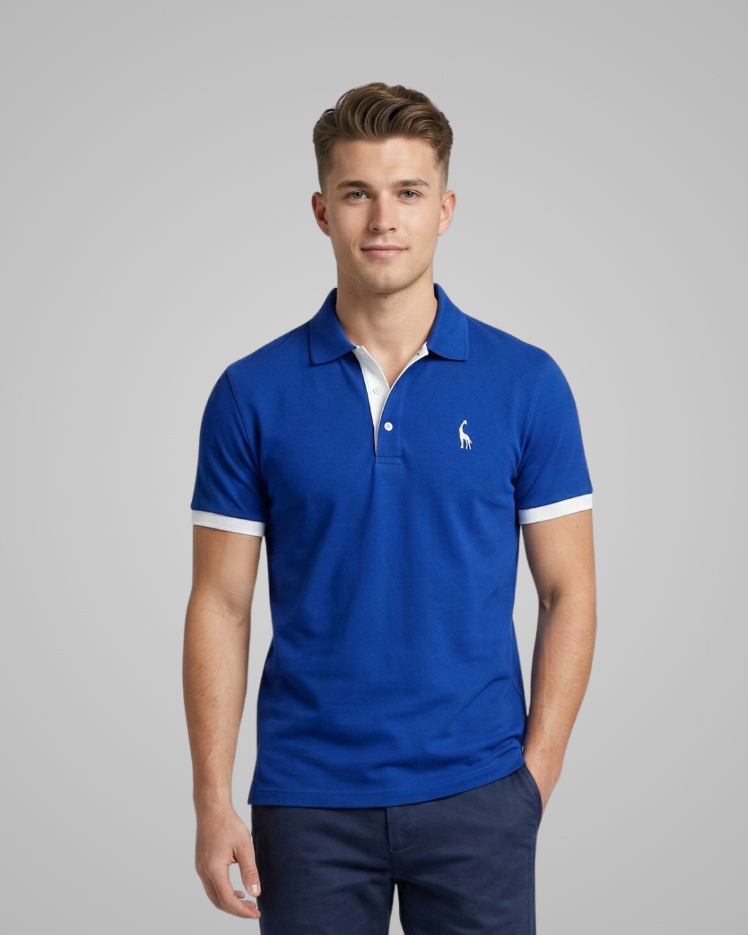 Man wearing a blue polo shirt with a logo on a gray background