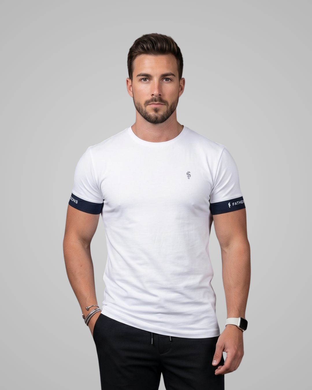 Man wearing a white t-shirt with dark arm bands on a gray background