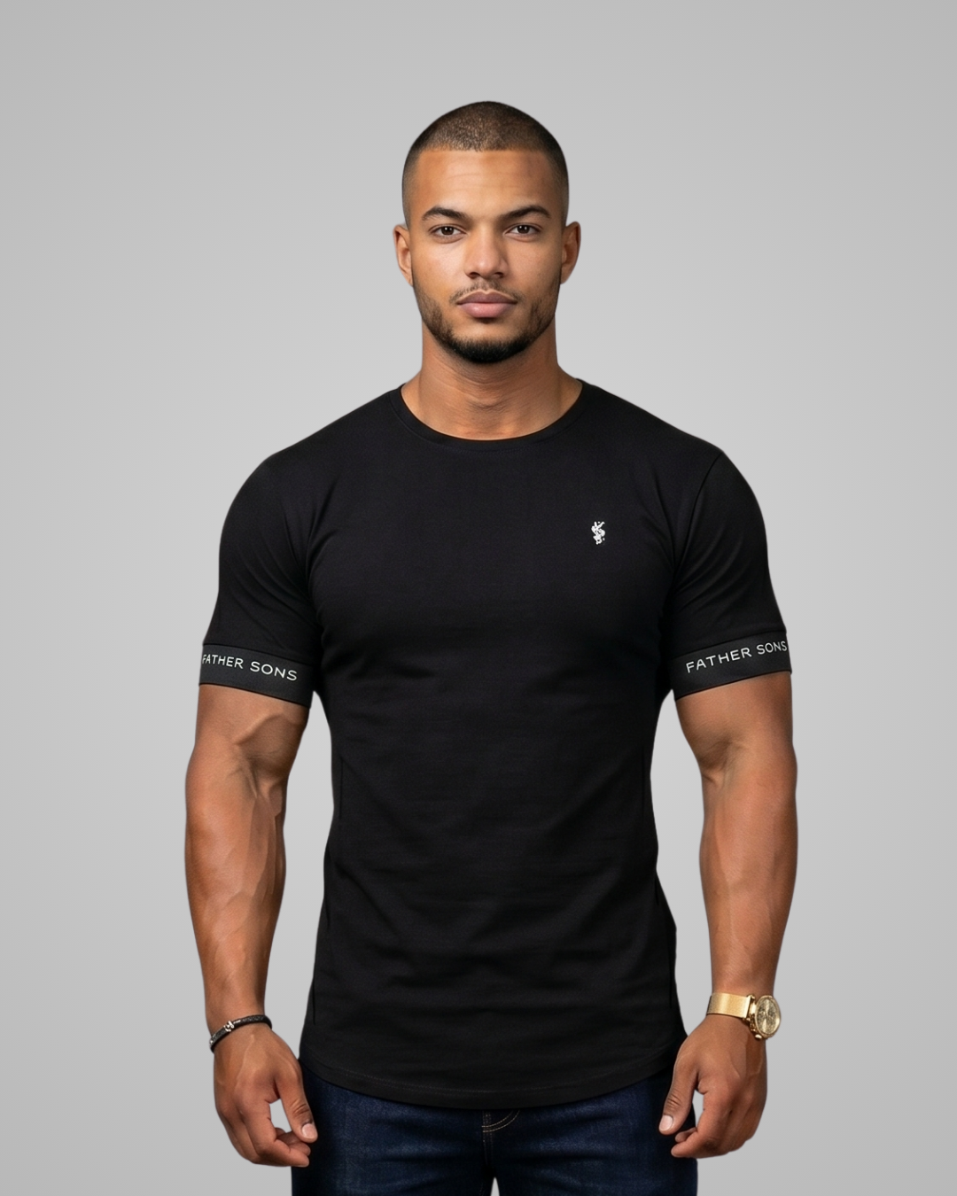 Man wearing a black t-shirt with branding on sleeves against a gray background