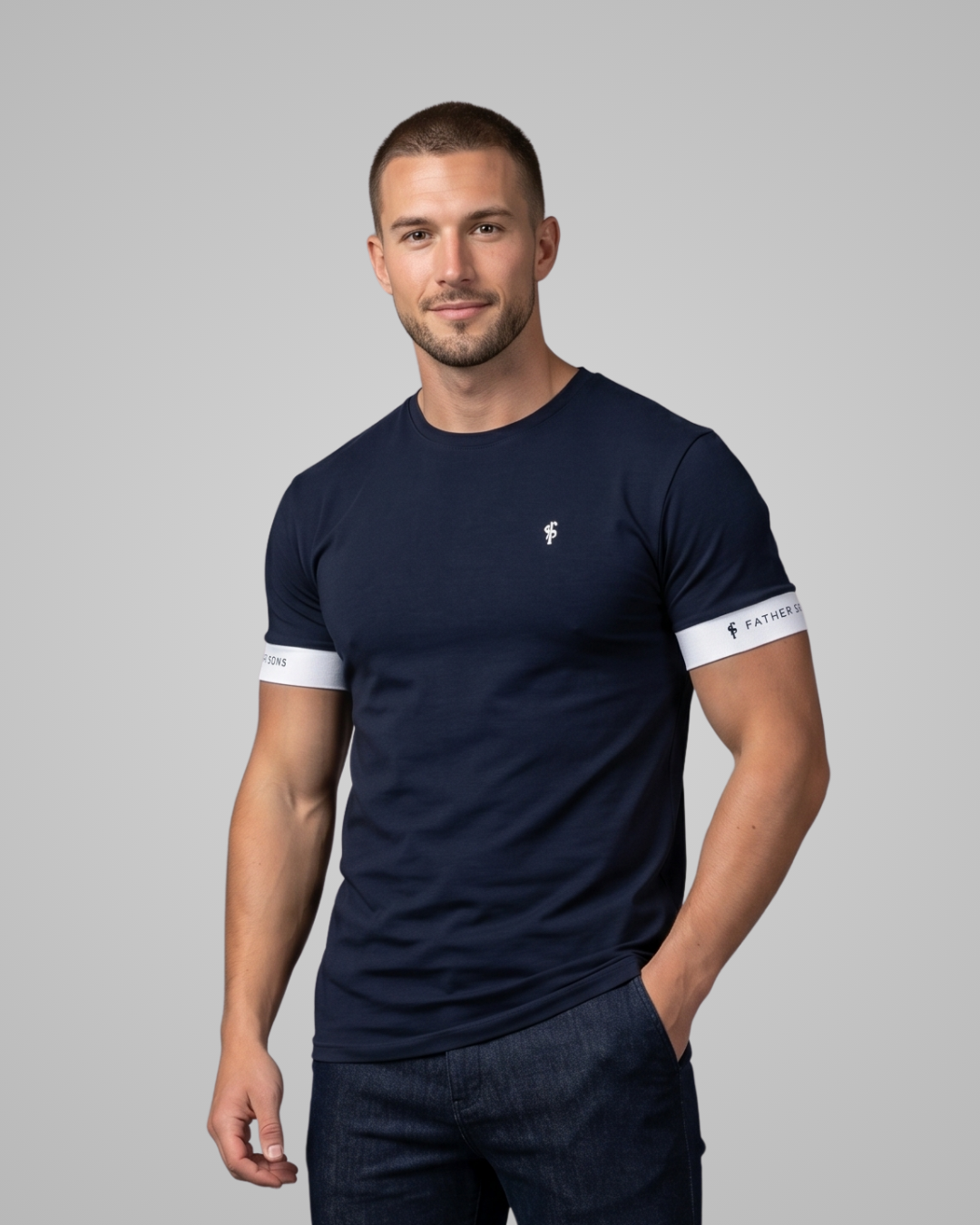 Man wearing a navy blue t-shirt with white accents on a gray background