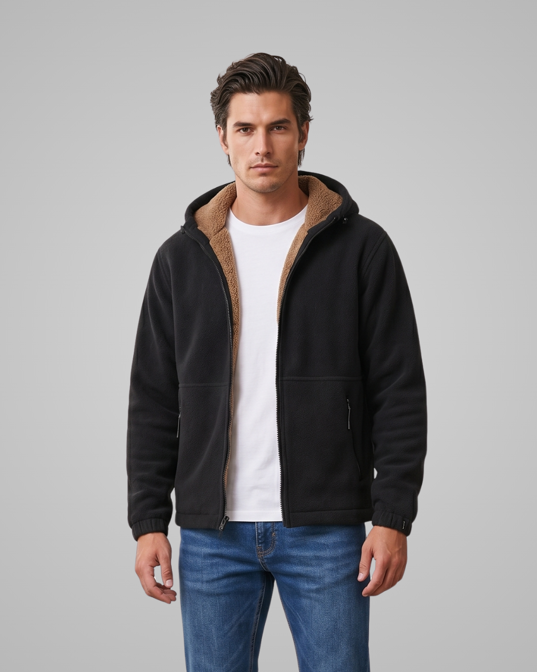 Man wearing a black fleece jacket with brown hood on a gray background
