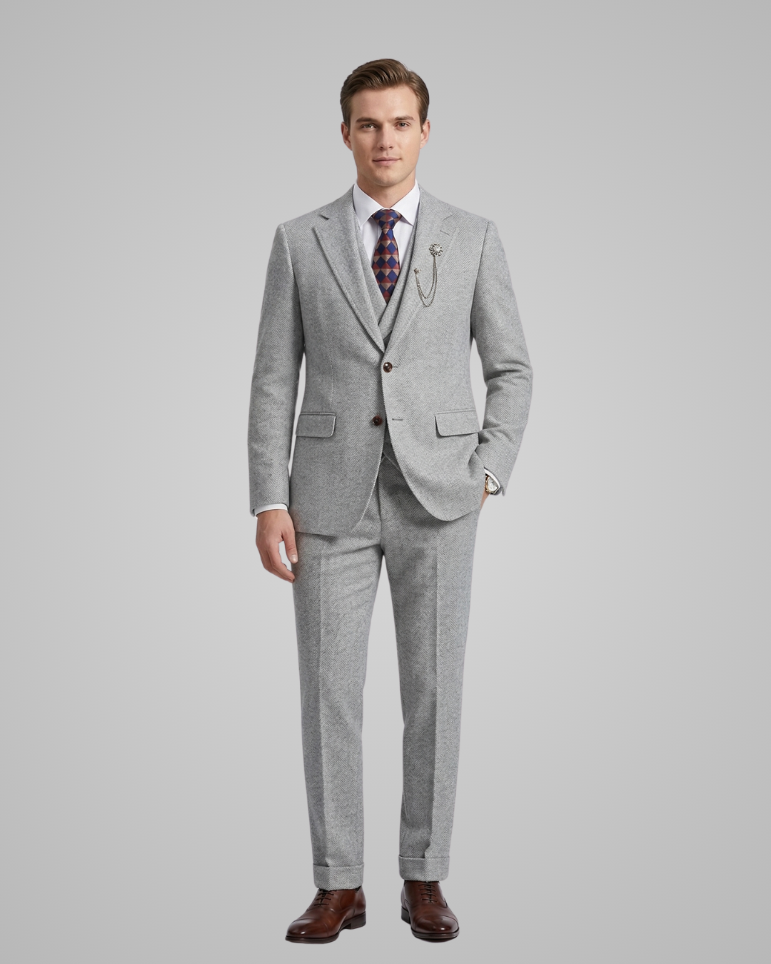 Man wearing a gray suit with a patterned tie on a light gray background