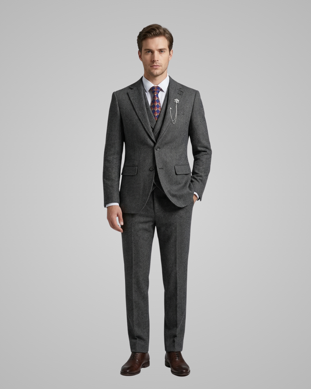 Man wearing a gray suit with a patterned tie on a light gray background