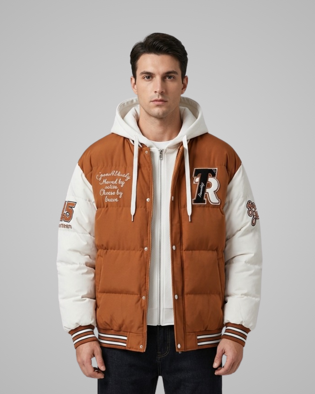 Man wearing a brown and white varsity jacket with letterman design on a gray background