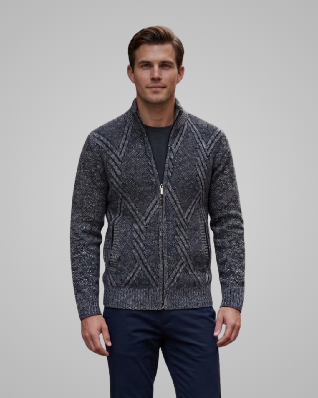 Man wearing a patterned gray sweater against a plain background