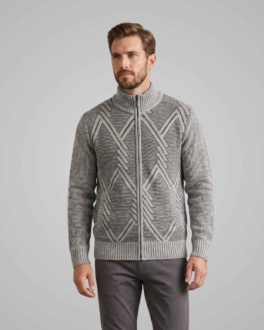 Man wearing a gray patterned sweater against a plain background