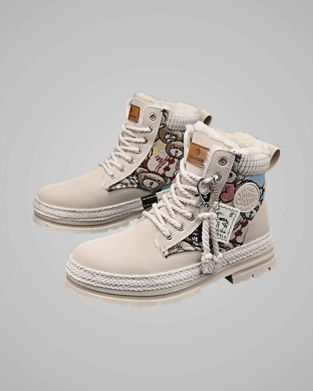 Pair of beige high-top sneakers with patterned design on a light gray background