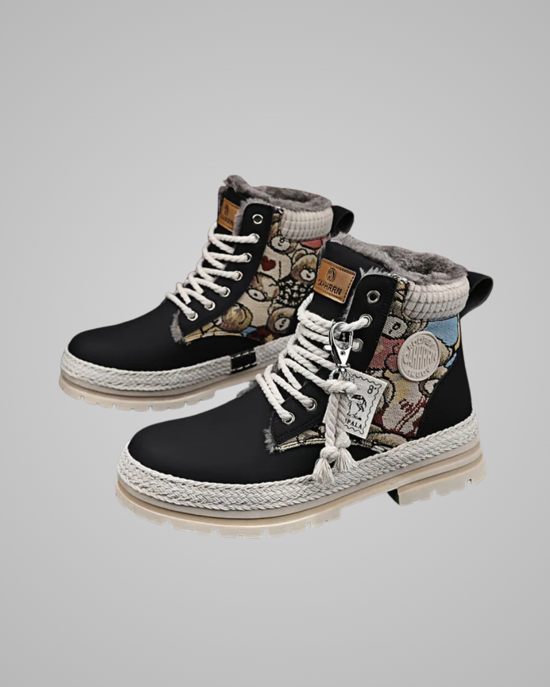 Pair of black high-top sneakers with floral patterns on a light gray background