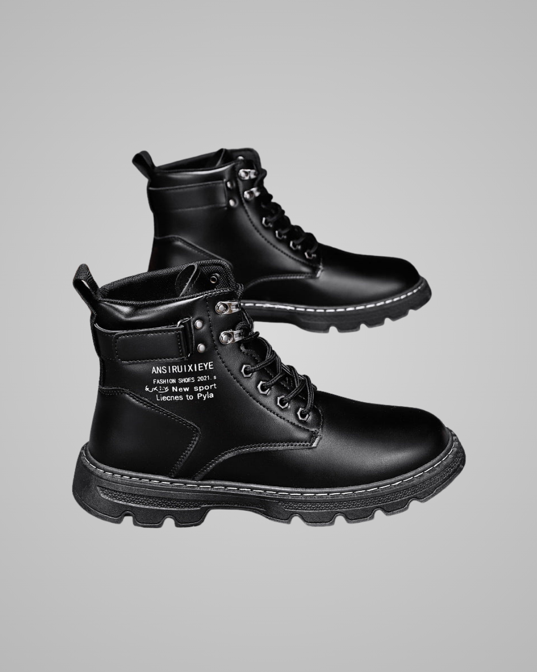 Black leather boots with branding on a gray background