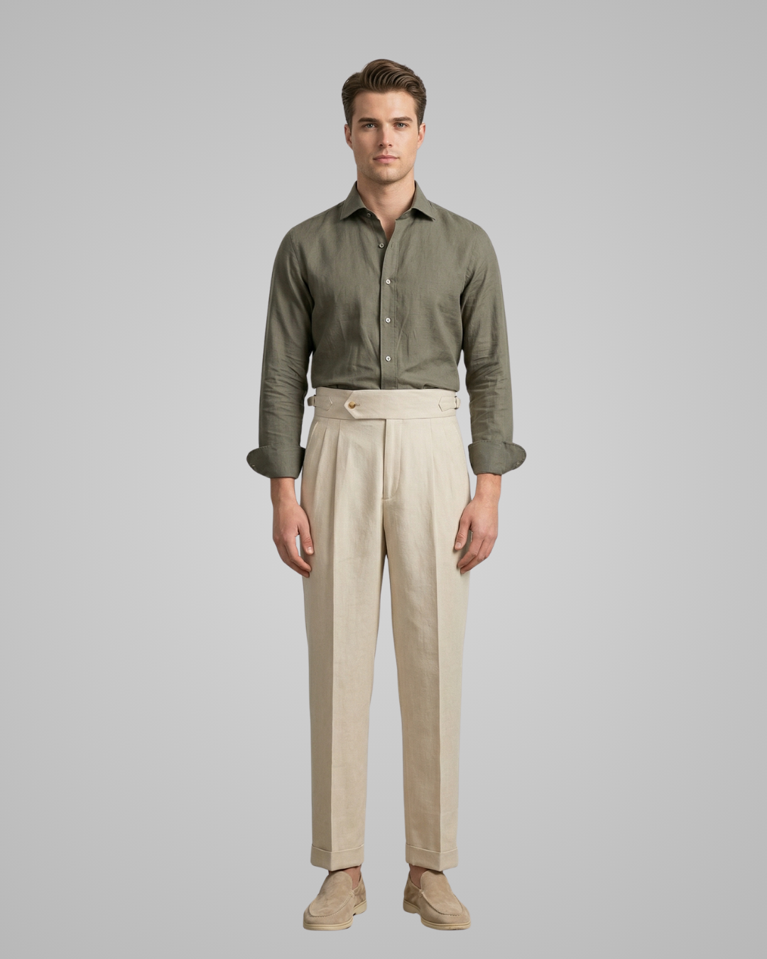 Man wearing a green shirt and beige pants on a gray background