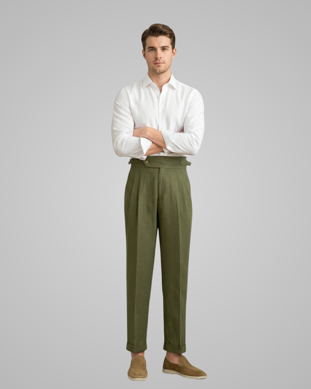 Man wearing a white shirt and green pants on a gray background