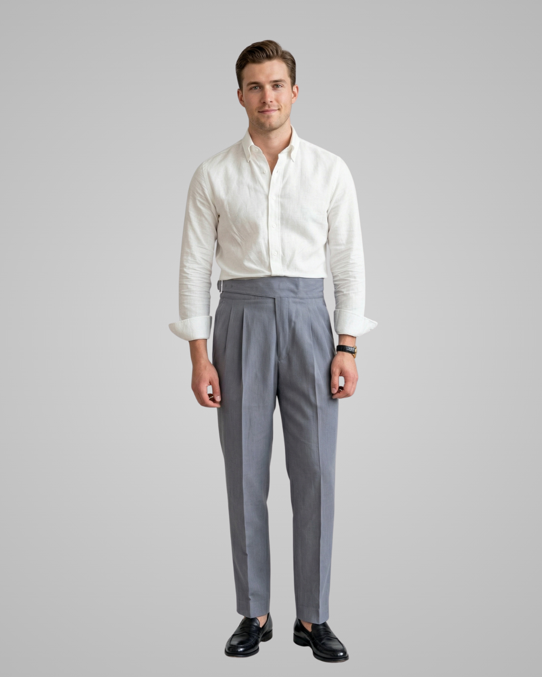 Man wearing a white dress shirt and grey pants on a gray background