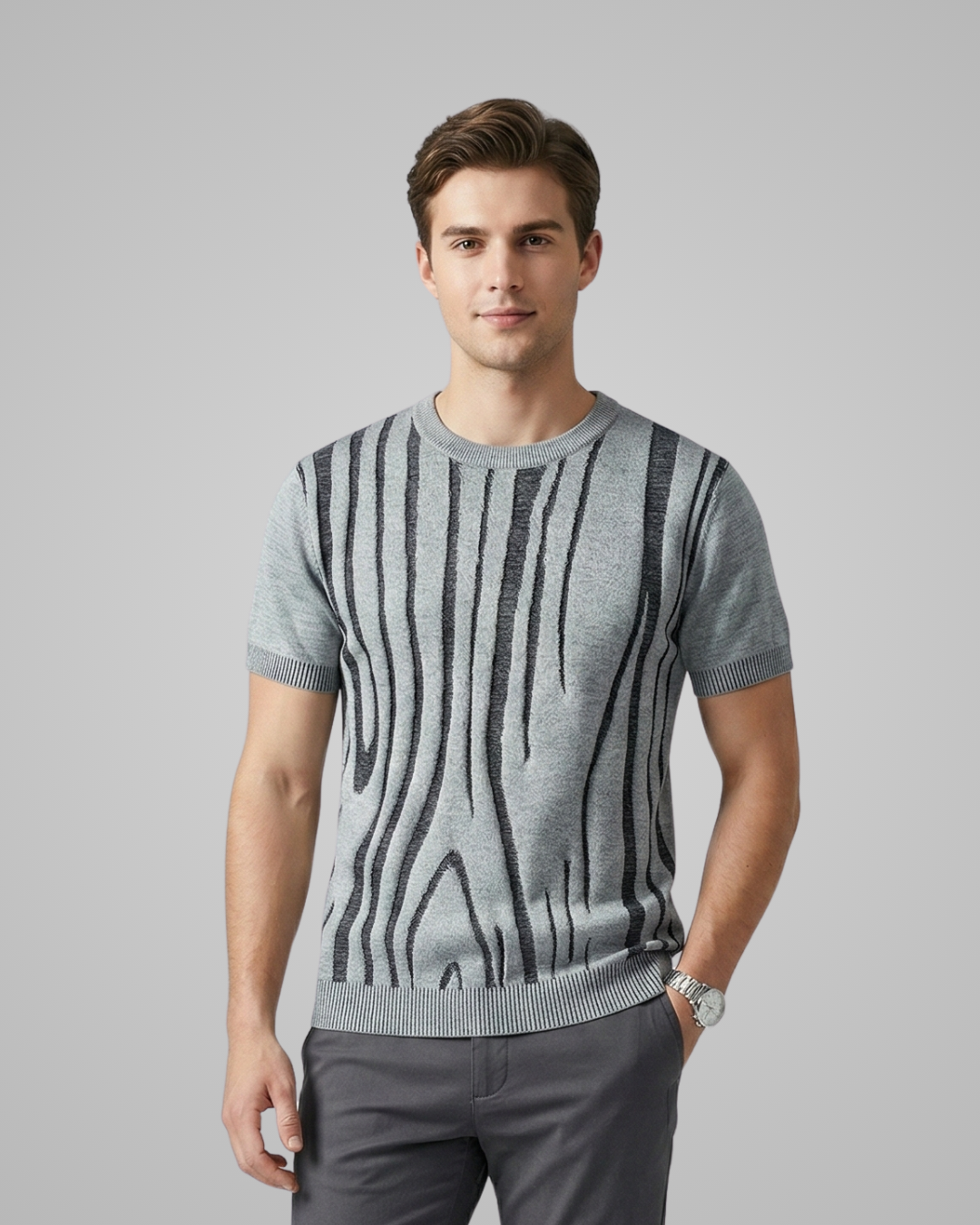 Man wearing a gray sweater with black pattern on a gray background