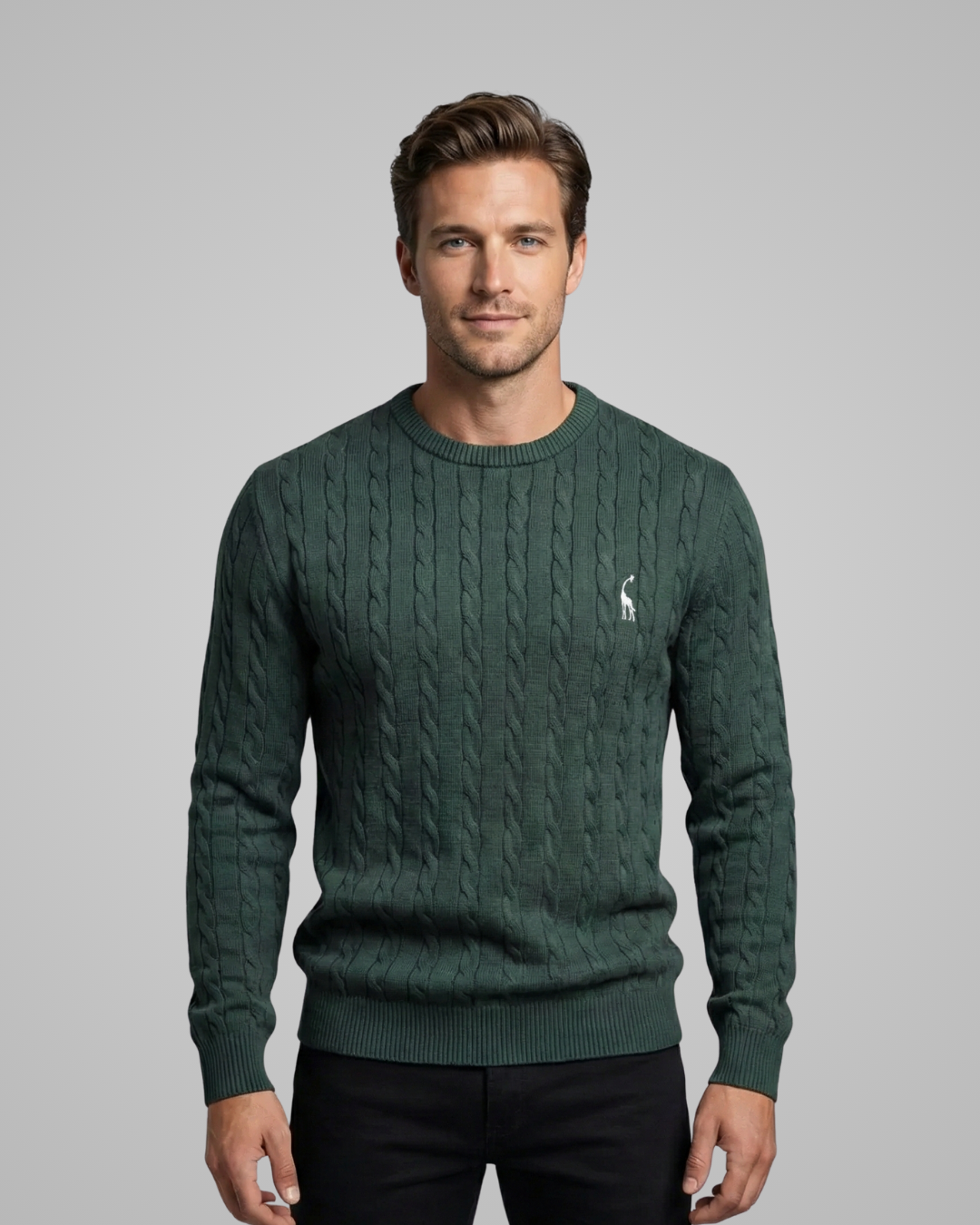 Man wearing a green cable knit sweater with a small logo on a gray background