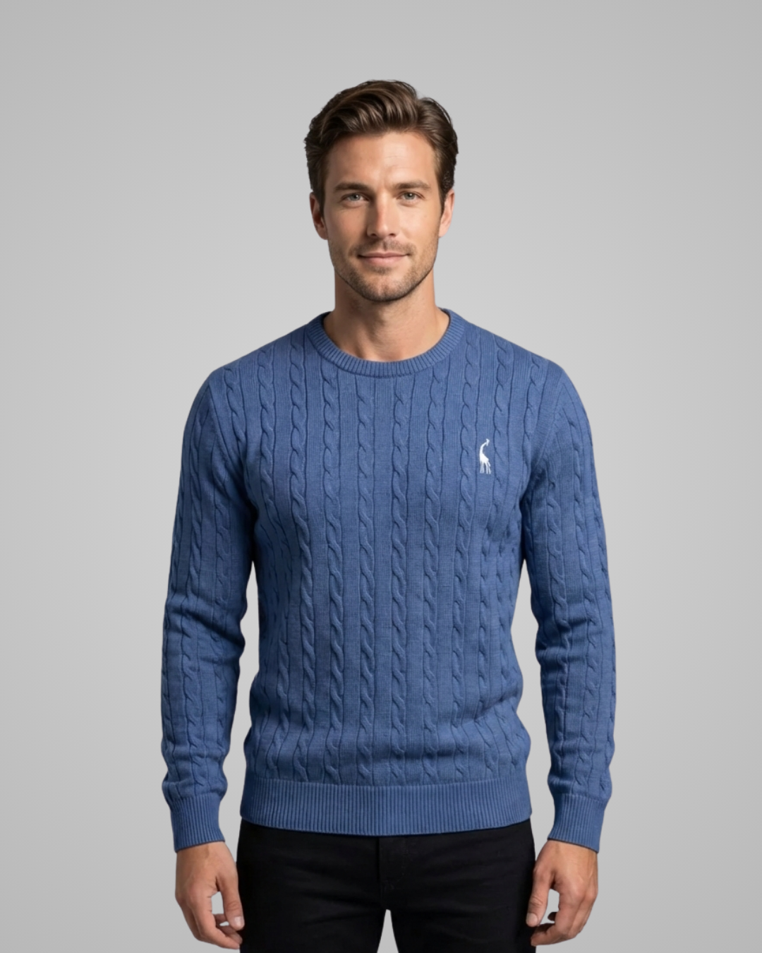 Man wearing a blue cable knit sweater with a small logo on a gray background