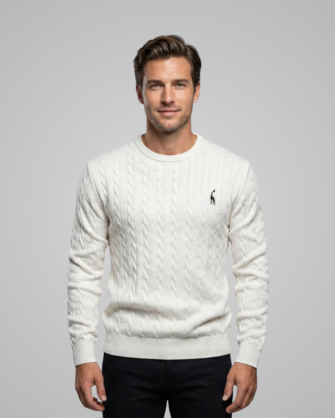 Man wearing a white cable knit sweater with a brand logo on a gray background