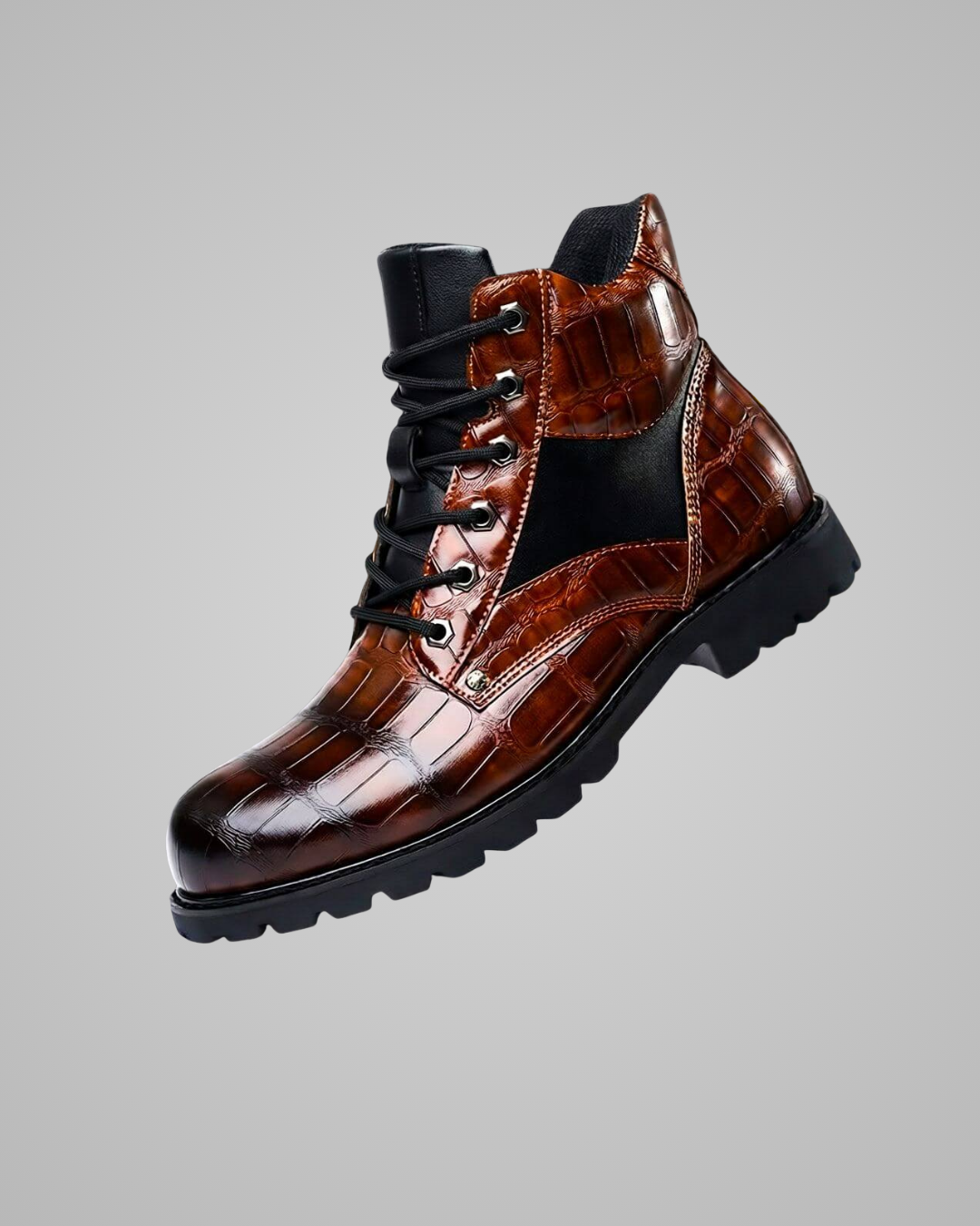 Brown leather boot with black sole on a gray background