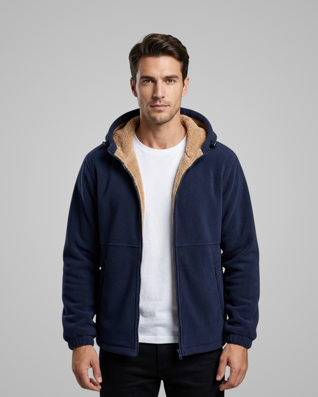 Man wearing a navy blue jacket with beige lining on a gray background