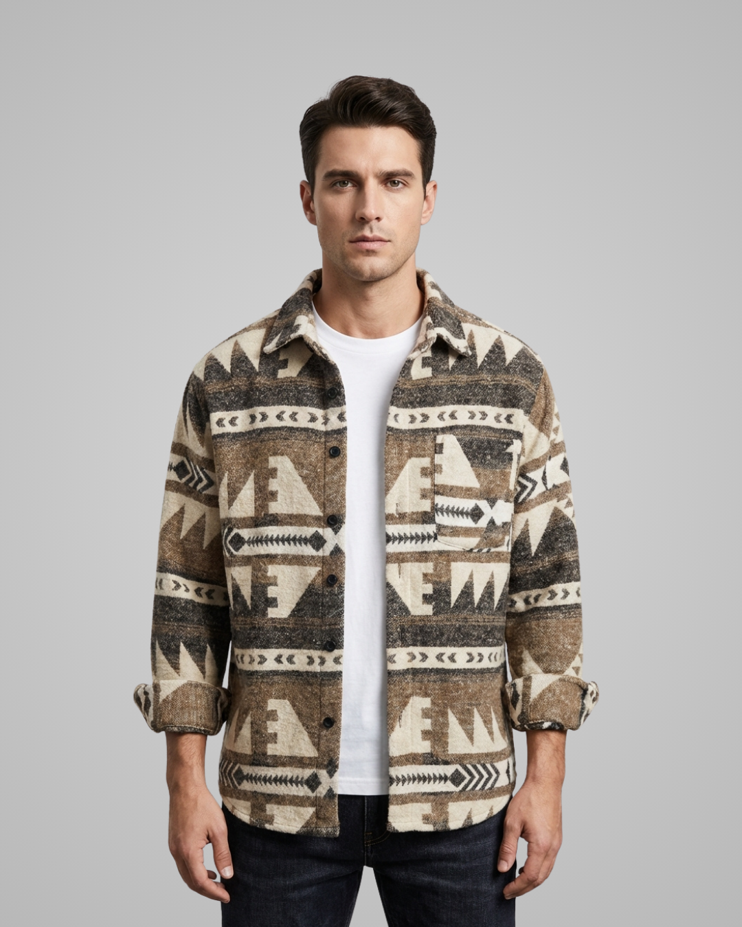 Man wearing a patterned shirt over a white t-shirt on a gray background