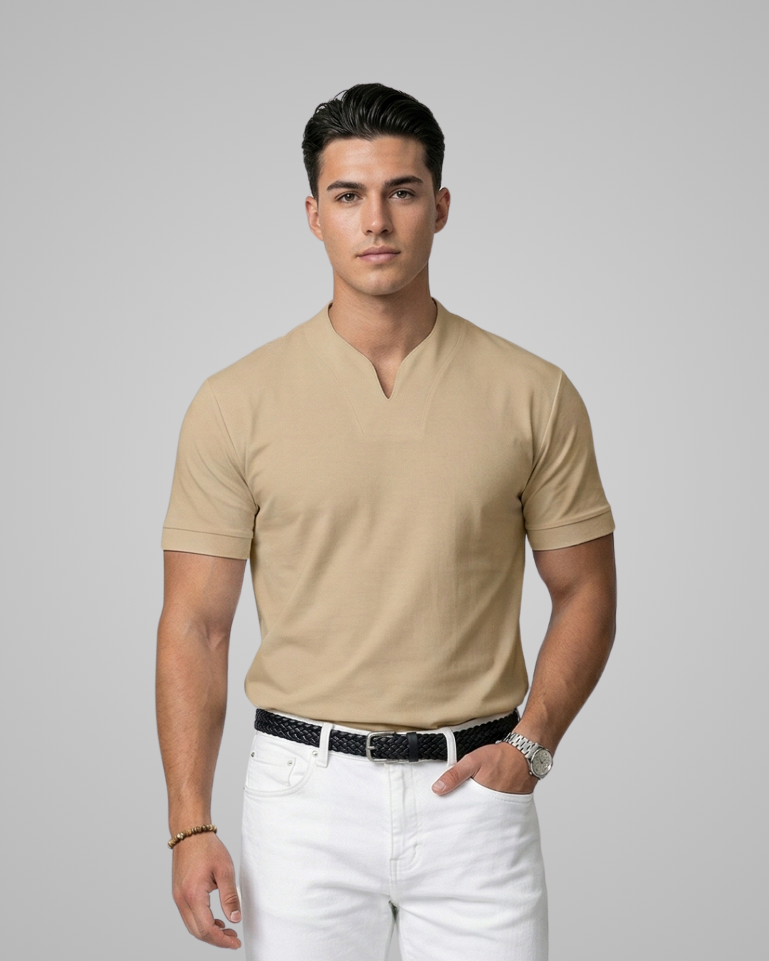 Man wearing a khaki polo shirt and white pants on a gray background