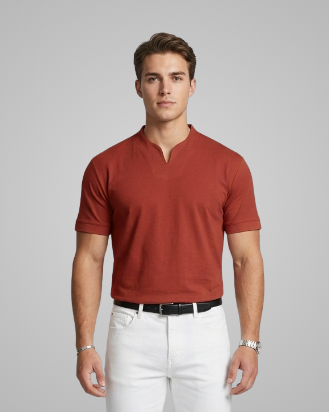 Man wearing a red polo shirt and white pants against a gray background