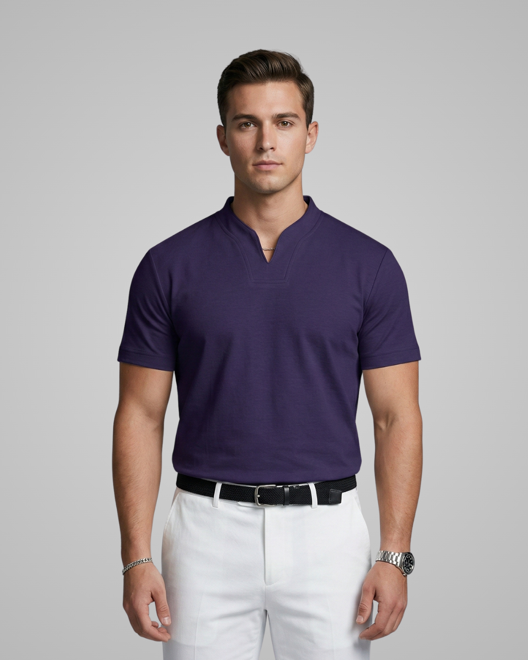 Man wearing a purple polo shirt and white pants on a gray background