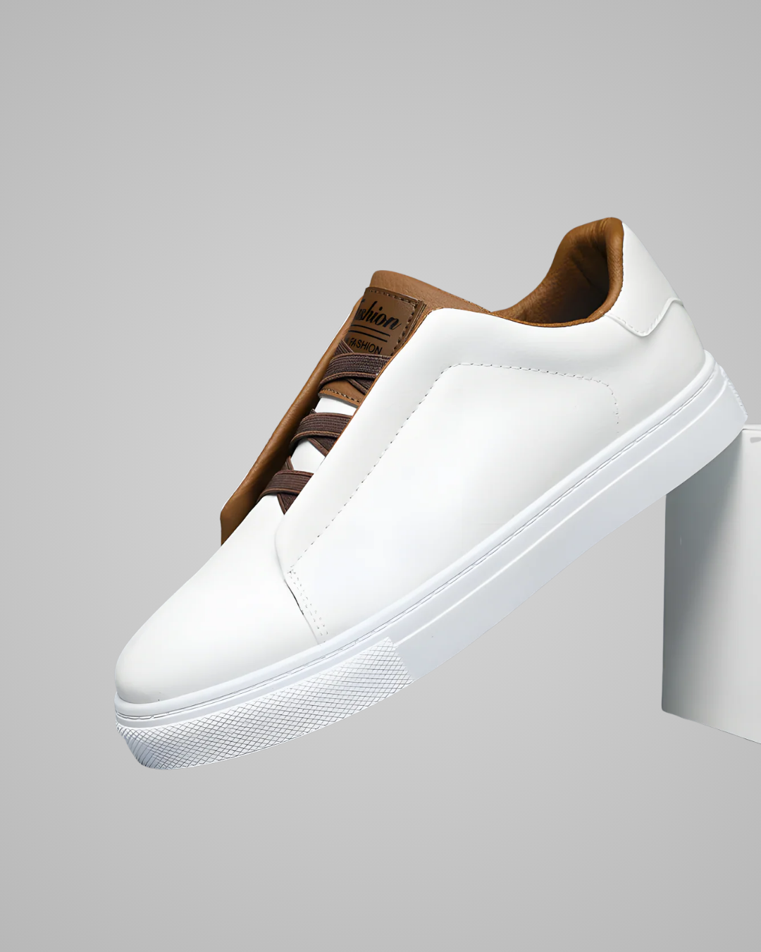 White sneaker with brown accents on a gray background