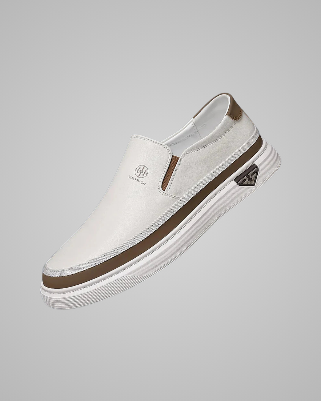 White slip-on sneaker with brown accents on a gray background