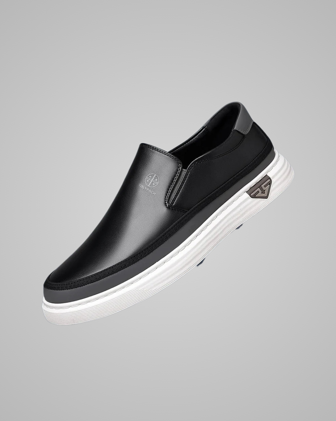 Black slip-on shoe with white sole on a gray background