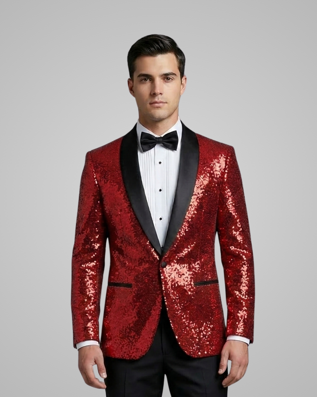 Man wearing a red sequin tuxedo with black lapels on a gray background