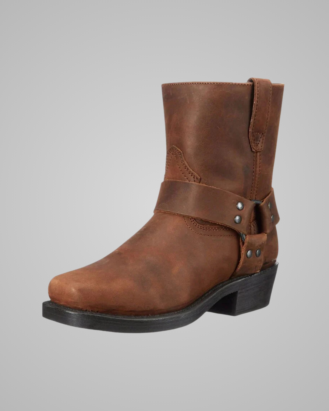Brown leather boot with strap and buckle on a gray background