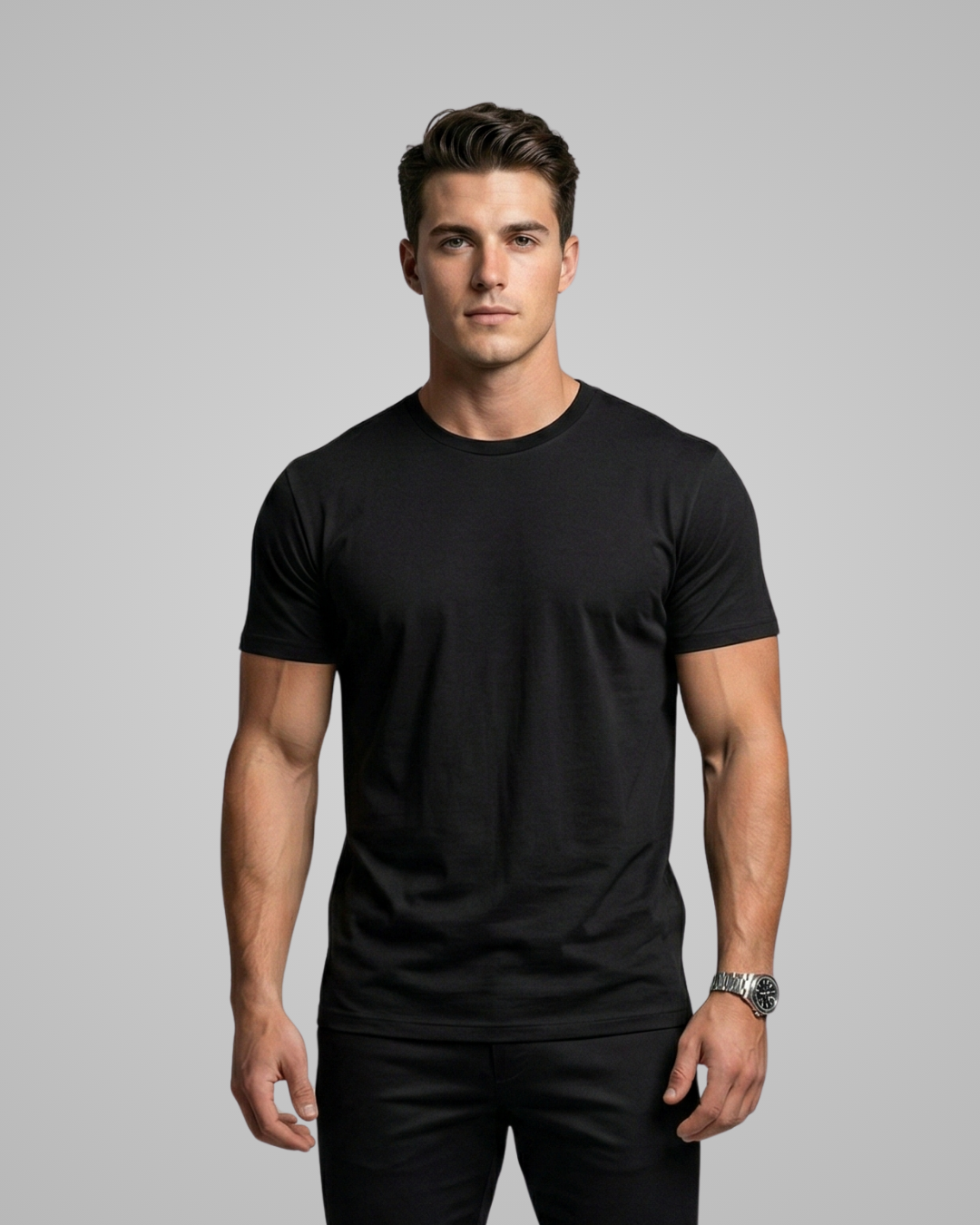 Man wearing a black t-shirt against a gray background