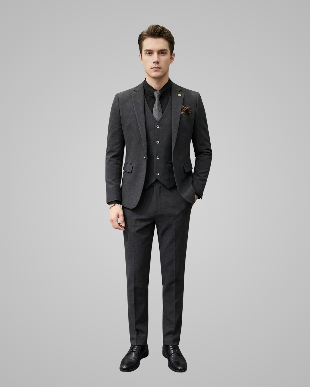 Man wearing a gray suit with a tie on a gray background