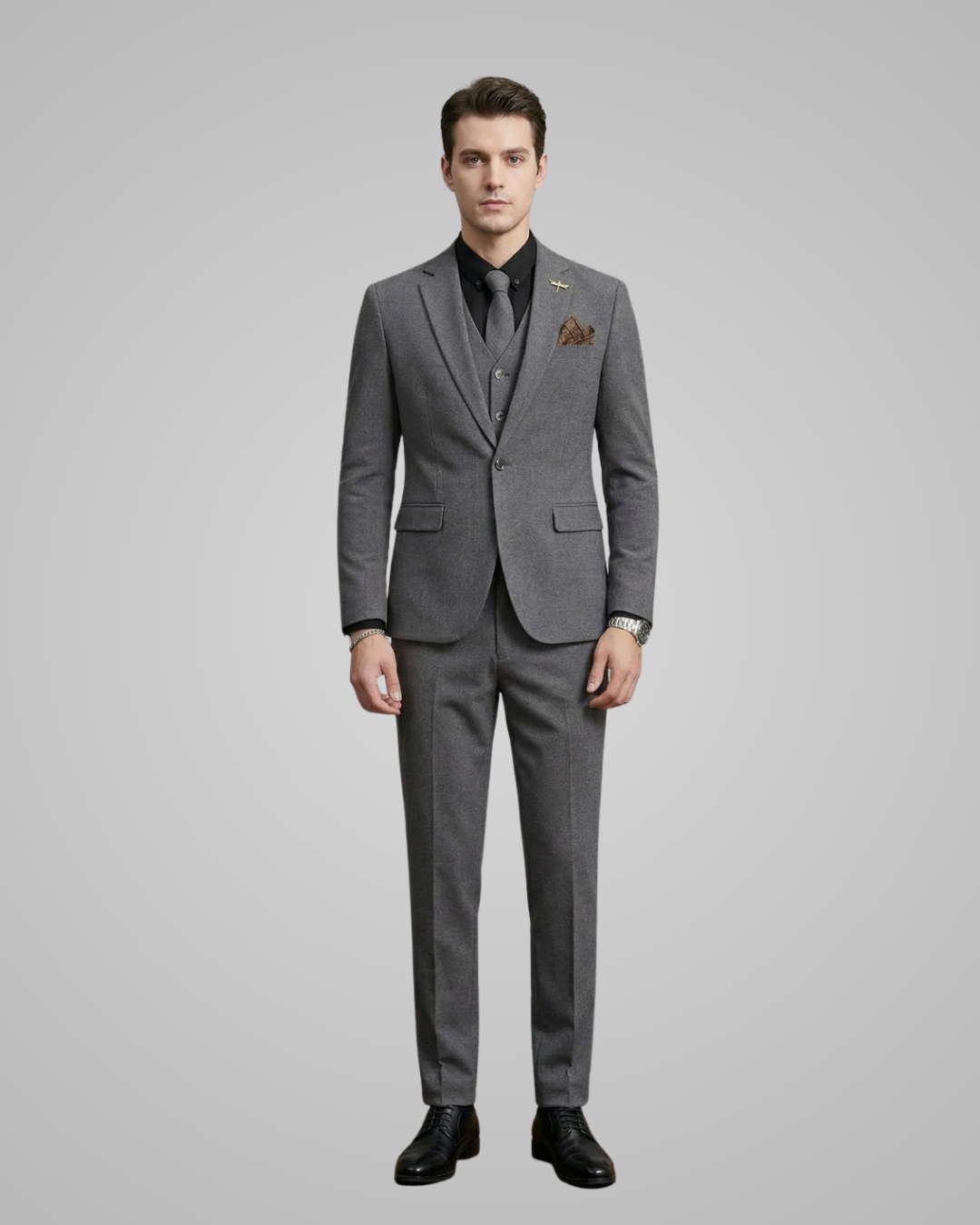 Man wearing a gray suit with a white shirt and black shoes on a gray background