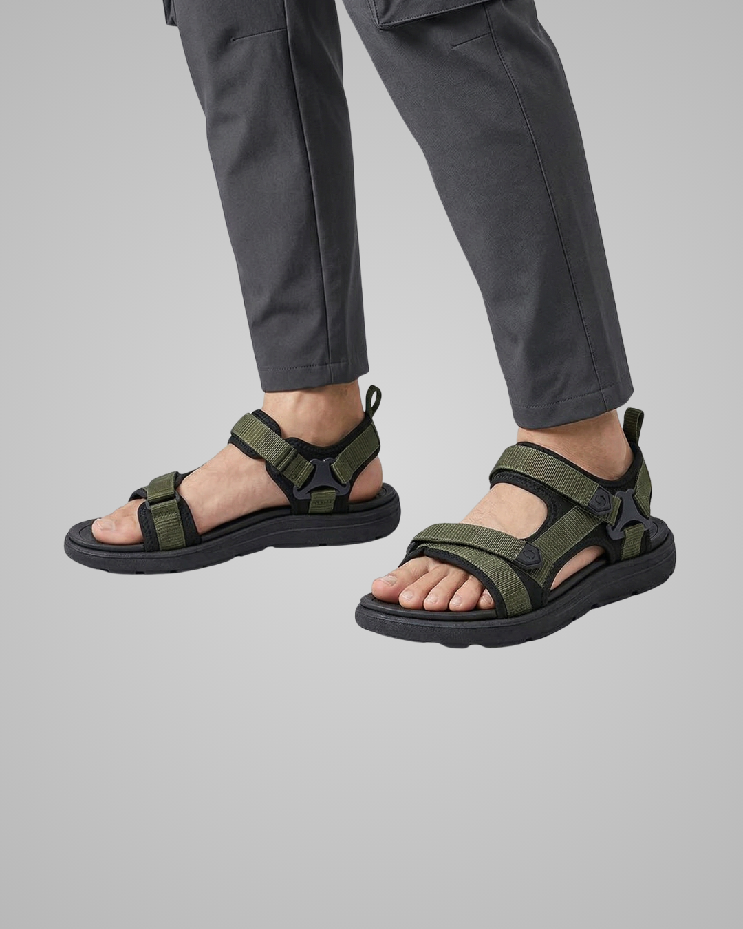 Person wearing green sandals on a gray background