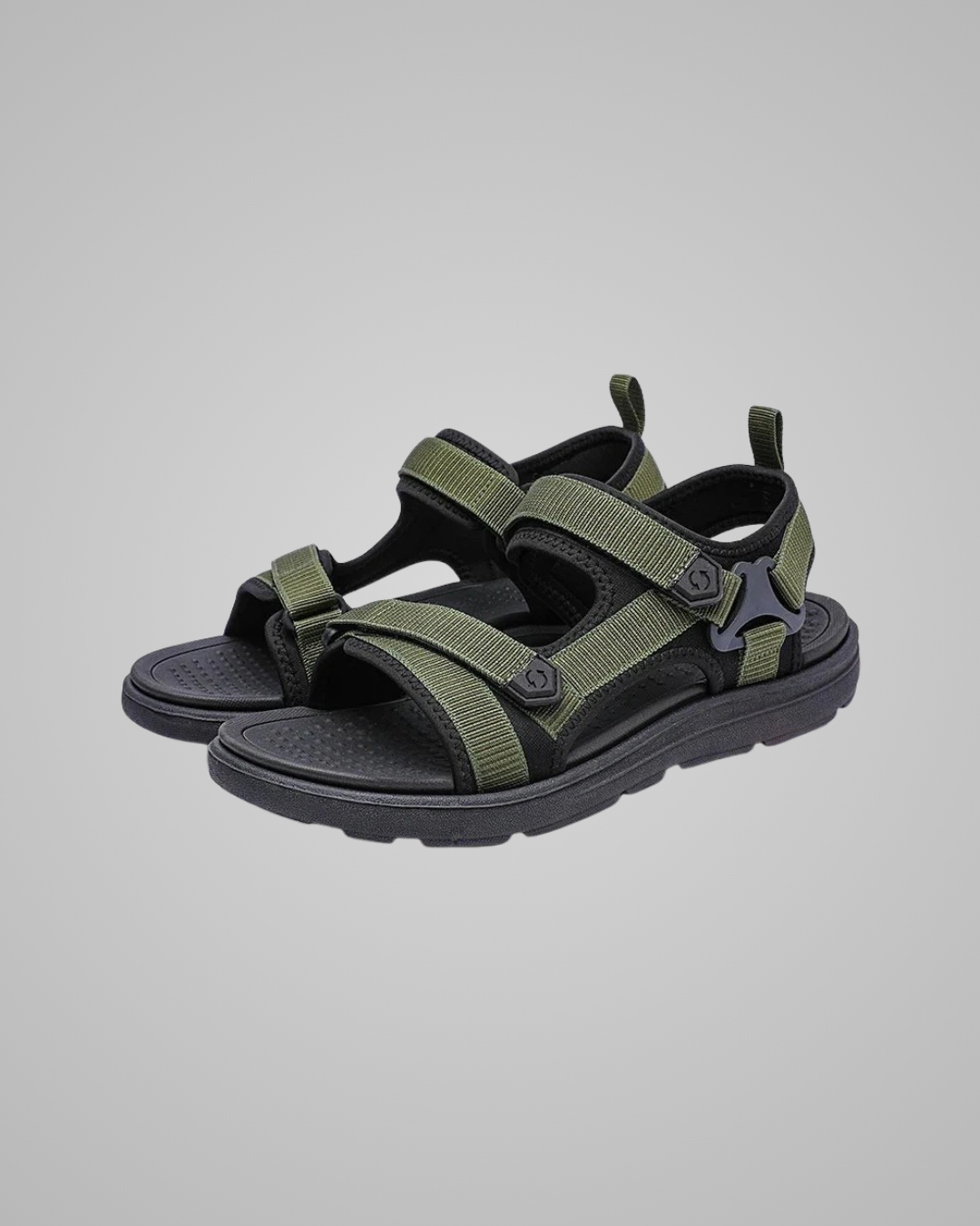 Green and black sandals on a gray background