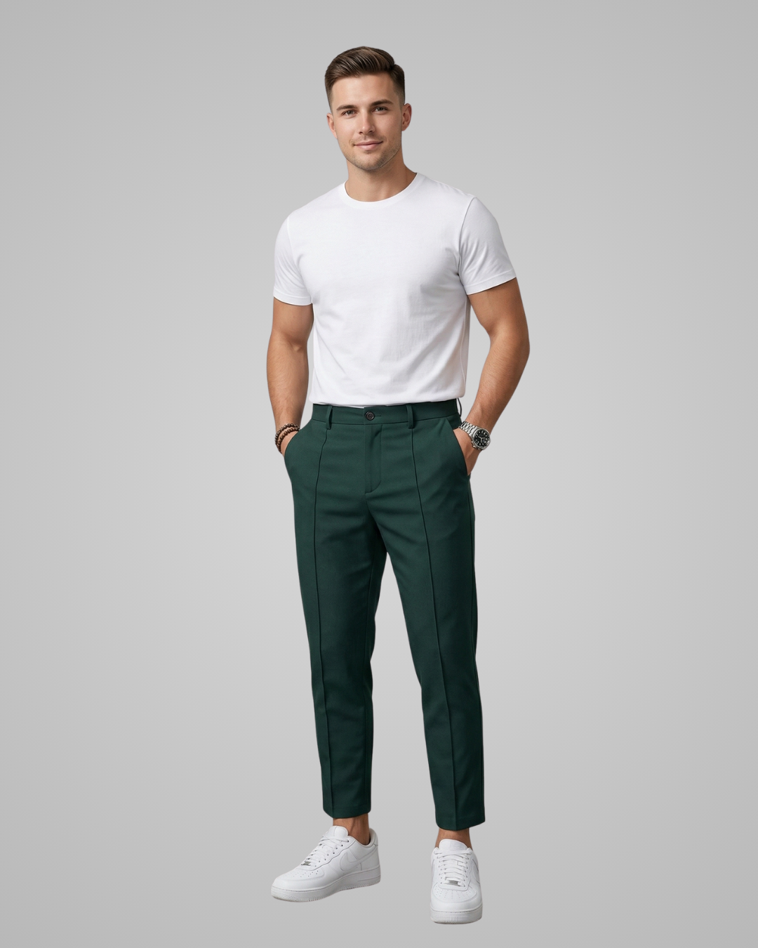 Man wearing a white t-shirt and green pants on a gray background